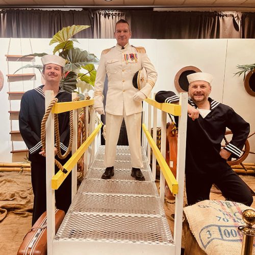 Captain and his sailors in a cruise-themed decor